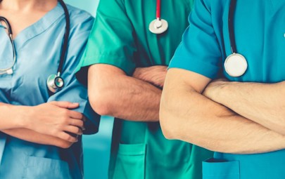 close up of three nurses with their arms crossed close up of three nurses with their arms crossed