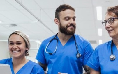 three medical professionals walking in hospital three medical professionals walking in hospital