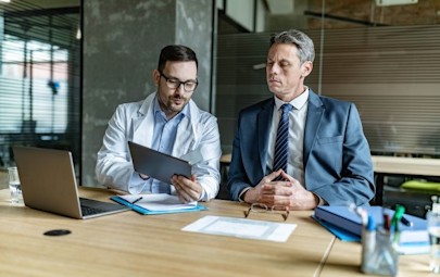 doctor and businessman discussing healthcare workforce strategies doctor and businessman discussing healthcare workforce strategies