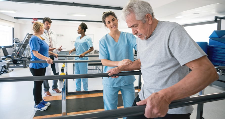 Physical therapist helping patient on a walking machine