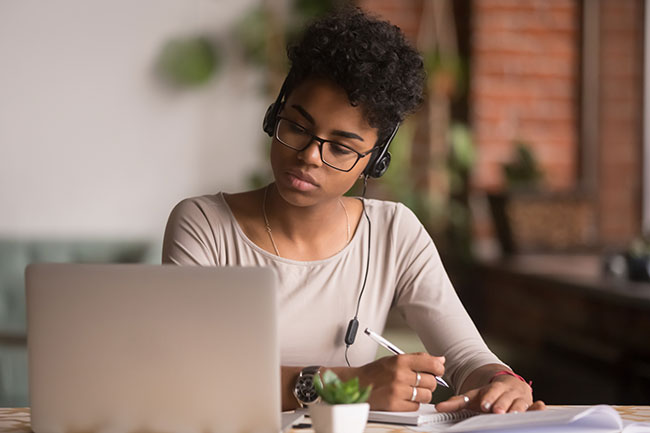 woman with headset attending webinar