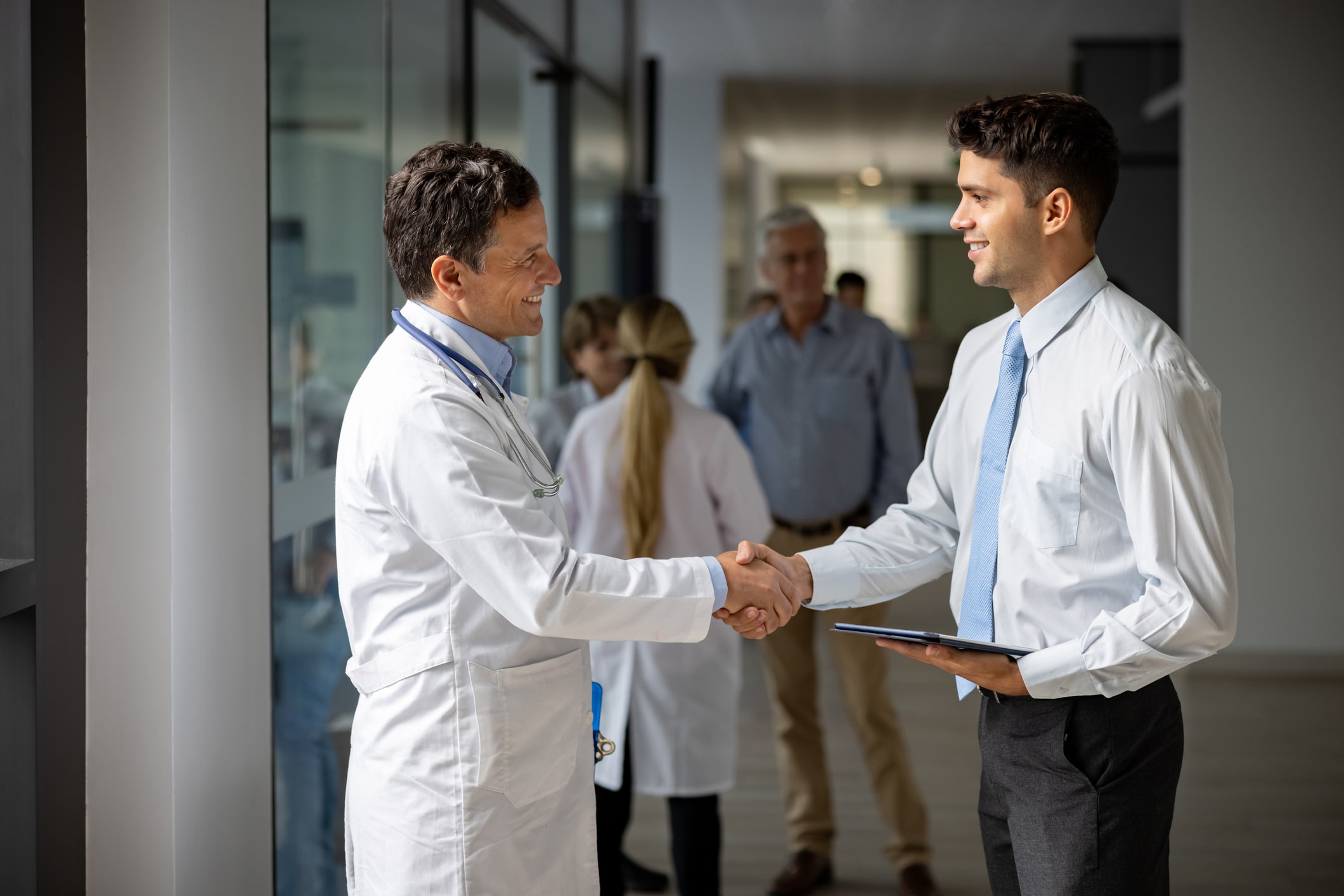 doctor and businessman shaking hands
