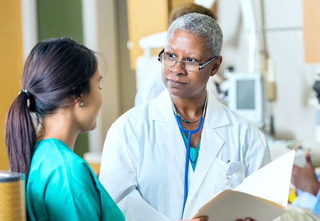 Female physician speaking with nurse