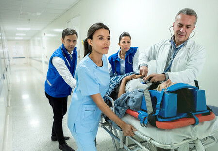 Trauma team rushing patient into operating room
