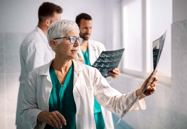Physicians looking at x-rays