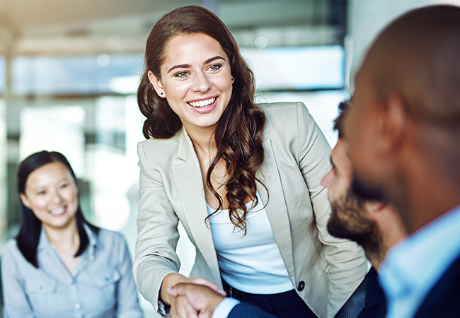 Business woman shaking hands in meeting