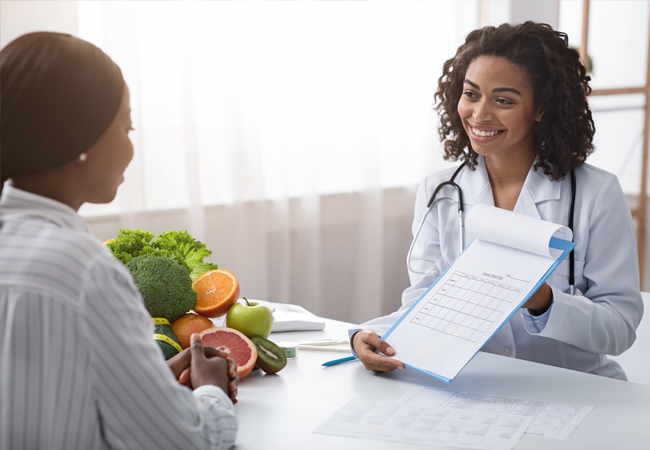 Female physician showing woman a document
