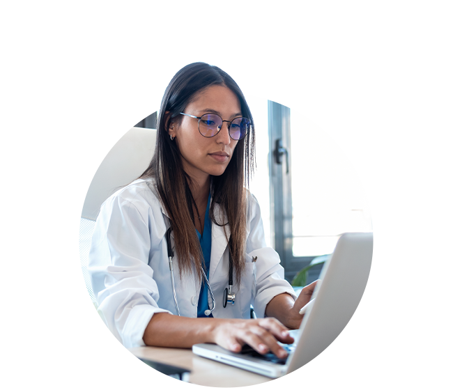 Female physician working on laptop